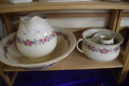 Washbowl and jug set decorated with pink flowers and ribbons
