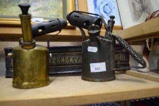 Two hand held gas torches and a wooden scoreboard