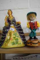 Pottery figure of a lady in ball gown together with a clockwork clown