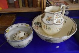 Washbowl and jug together with a matching soap dish and chamber pot decorated with flowers