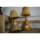 Two carved wooden mushrooms