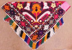 An embroidered triangular panel, with American Indian style fringed and beaded border and polychrome