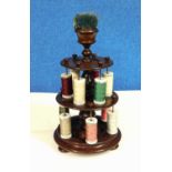 A 19th century two tier mahogany cotton reel holder with pincushion top, approx. 33cm high