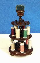 A 19th century two tier mahogany cotton reel holder with pincushion top, approx. 33cm high