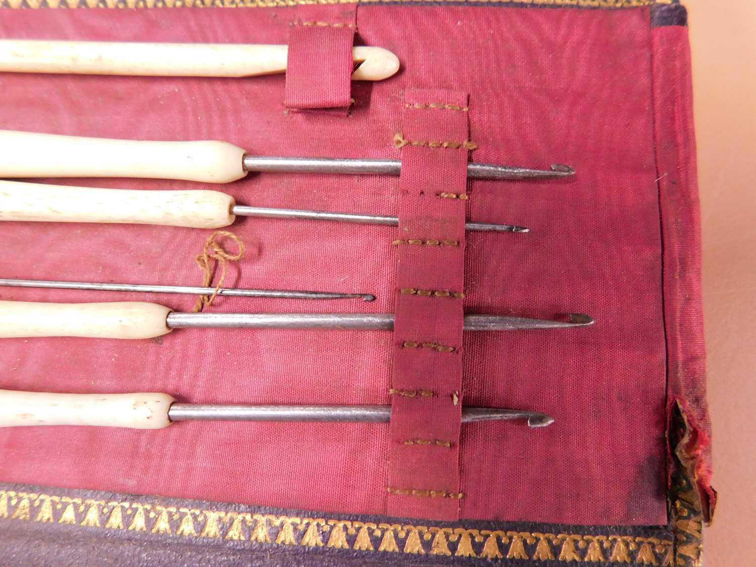 A leather case of various needlework tools, the green leather case with gilt decoration, opening - Image 8 of 10