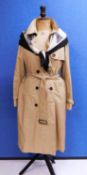 A beige Aquascutum trench coat, double breasted with belted waist, size 12 together with an