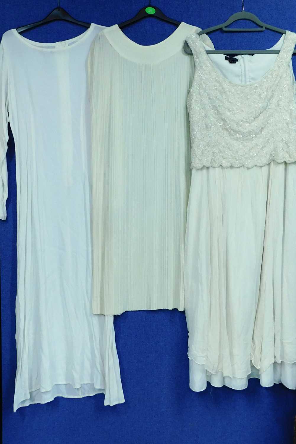 Three cream lady's occasion wear dresses to include a sleeveless shift by Monsoon Twilight with