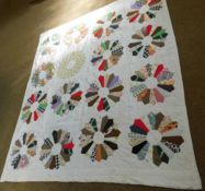 A patchwork quilt, with cream ground and multi colour patchwork design, approx. 168 x 190cm