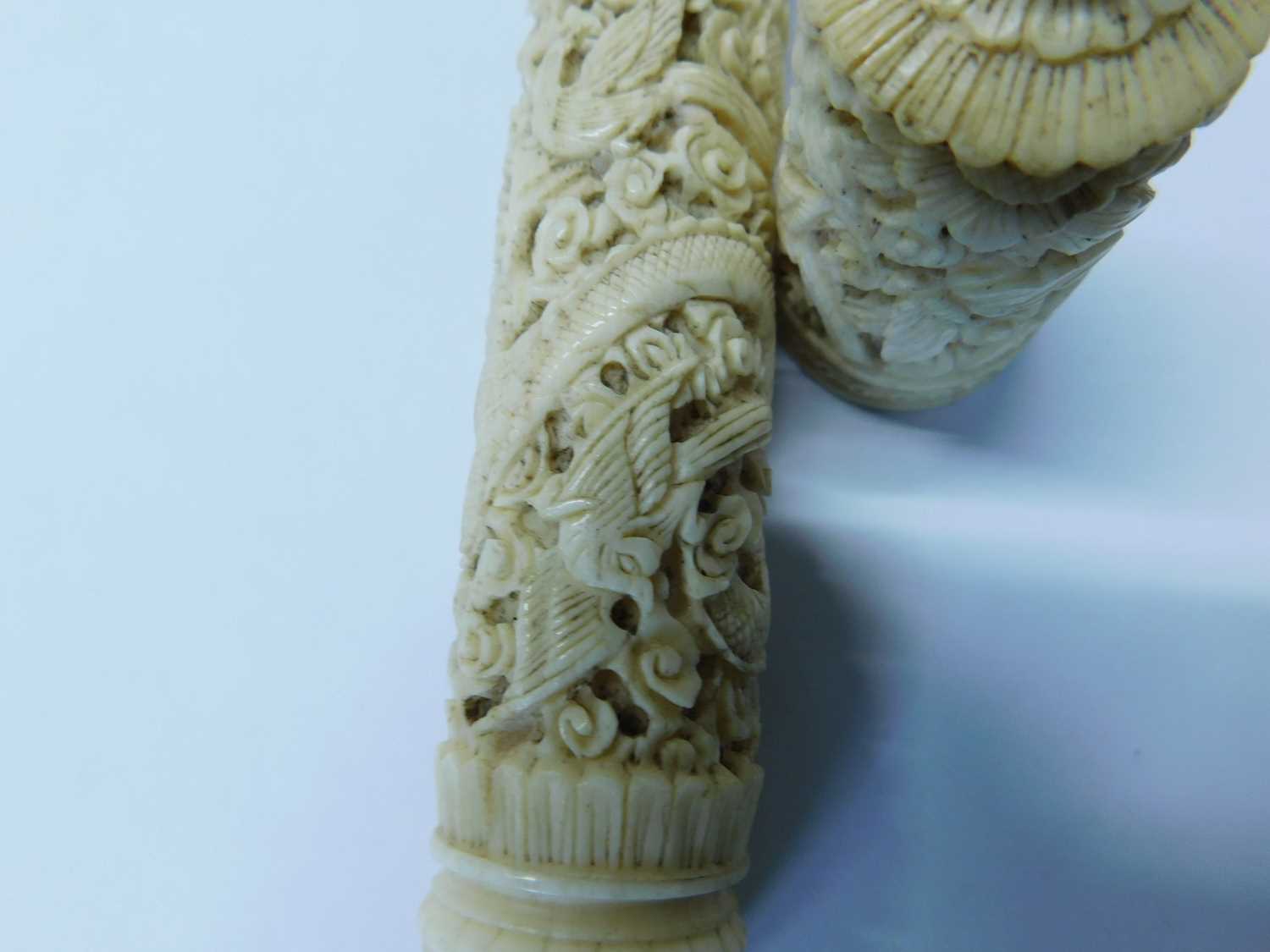 An Eastern carved bone needle case, the round case intricately carved with dragons, birds and - Image 5 of 6