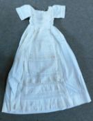 A late 19th / early 20th century christening gown, the cotton gown with short sleeves, broiderie