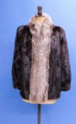 A lady's fur jacket, the deep brown fur with fox fur trim around collar and front fastening good