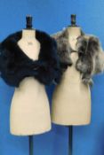 Two sheepskin wraps, one in black by Claudia London with black buckle fastening, the other in