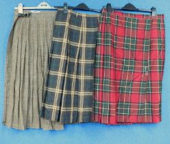 Three kilts, one by Glendonald of Scotland with leather buckle, size 14, one by Paul Separates, size