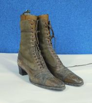 A pair of late 19th/early 20th Century brown leather and suede healed boots with pointed toes,