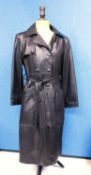 A lady's full length brown leather coat by Higgs, double breasted with front pockets and tie