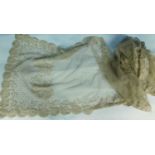 A Nottingham lace shawl with scalloped floral edges, with a border of flowers and all over dot and