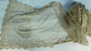 A Nottingham lace shawl with scalloped floral edges, with a border of flowers and all over dot and