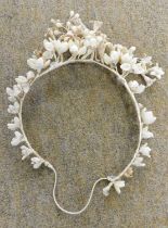 A c.1940's wedding headdress and lace veil, the headdress with ribbon wrapped wire frame and wax