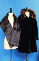 A mink stole and a lady's black faux coat with brown fur trim, (2)