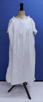 A ladies white cotton nightgown, bib fronted with vertical pintuck and scalloped broiderie
