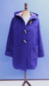 A lady's blue wool mix duffle coat, with zip fastening and wooden buttons, path pockets and hood, by