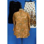 Three items of circa 1970's lady's wear, to include a high necked mutton sleeved orange paisley