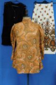 Three items of circa 1970's lady's wear, to include a high necked mutton sleeved orange paisley