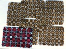 Seven 'Welsh blanket' placemats, six in brown and orange, one in red and teal, each approx 20 x
