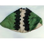 A late 19th/early 20th century children's cape, the olive green silk arc with tailored shoulders