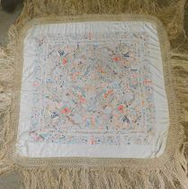 A late 19th century Chinese embroidered shawl, the cream silk shawl with allover embroidery of