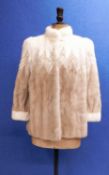 A lady's fur jacket, the cream and beige brown fur with dyed pattern and single hook fastening