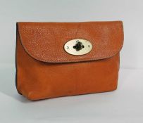 An orange Mulberry purse, with flap and brass lock closure, with Mulberry stamp to front and