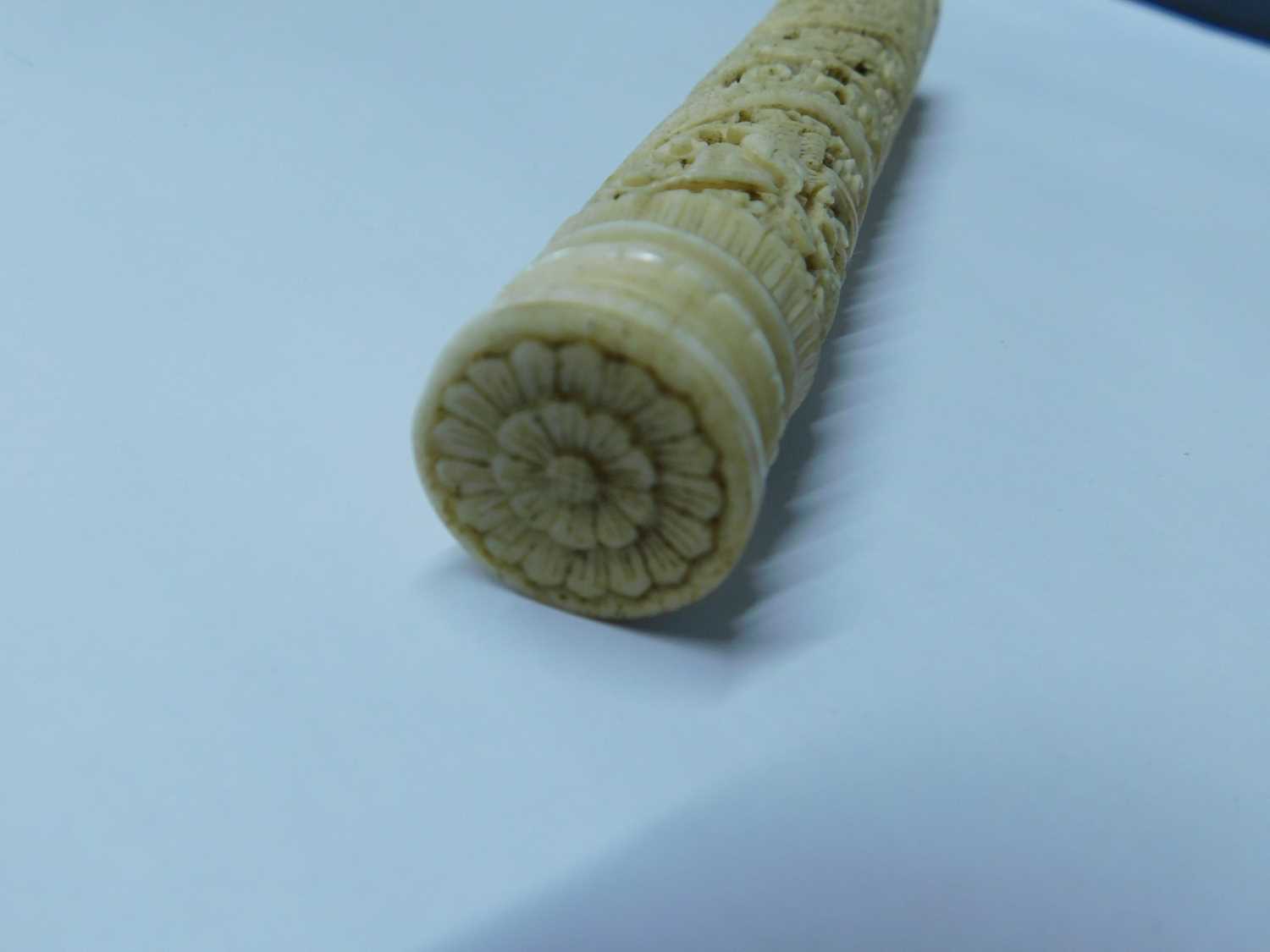 An Eastern carved bone needle case, the round case intricately carved with dragons, birds and - Image 4 of 6