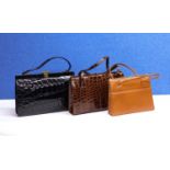 Three mid 20th Century lady's handbags to include a black patent leather mock croc bag with brass