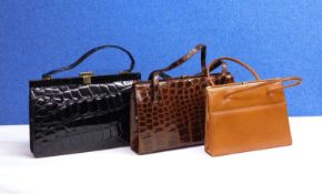 Three mid 20th Century lady's handbags to include a black patent leather mock croc bag with brass