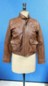 A lady's Ralph Lauren Polo tan leather jacket, zip fronted with front patch pockets, zip detail to