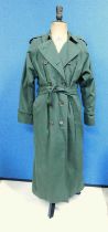 A lady's green Burberry trenchcoat, double breasted with side pockets, tie waste and buckle detail