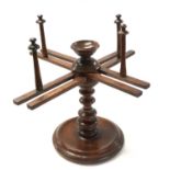 A 19th Century turned walnut wool winder of typical form with adjustable arms and a circular