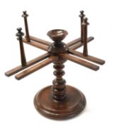 A 19th Century turned walnut wool winder of typical form with adjustable arms and a circular