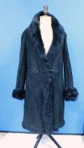 A lady's sheepskin coat by Higgs, the black coat with double breasted front, turn-up sleeves, duffle
