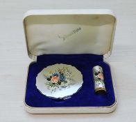 A cased Stratton compact and lipstick, both with satin finish decorated with flowers, in