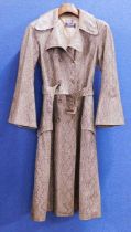 A c.1960's faux snakeskin trenchcoat by Donatella Boutique, France, single breasted with bell
