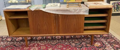 A mid Century Danish teak sideboard by Axel Christensen Odders, fitted with sliding doors and