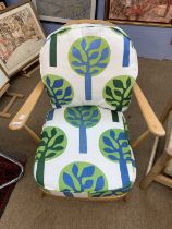 A vintage Ercol lightwood armchair with later upholstery