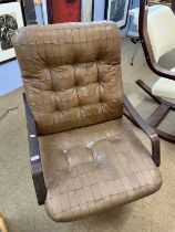 A mid Century brown leather upholstered revolving armchair (worn condition)