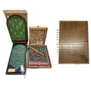 A collection of vintage wooden games, to include: - Boxed pin football - Boxed Tethered Skittles