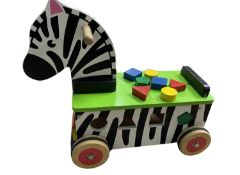 A ride on wooden zebra, with inbuilt shapes puzzle