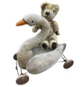 A pair of vintage stuffed toys, to include: - Swan mounted to a wheeled frame - A small teddy bear