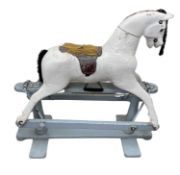 A modern wooden white rocking horse, mounted to blue painted base, in need of restoration. Size