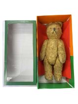 A small early 20th century teddy bear, possibly a carnival bear.